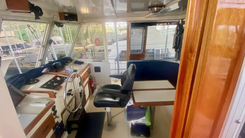 Slide: The Image of Interior of 1989 Kadey-Krogen Manatee 36 boat, featuring helm and seating area. - 14