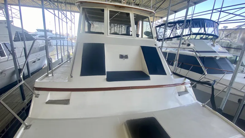 Slide: The Image of 1989 Kadey-Krogen Manatee 36 yacht docked in a marina, showcasing its spacious deck. - 17