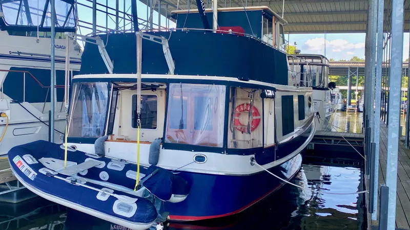 Slide: The Image of 1989 Kadey-Krogen Manatee 36 yacht docked with inflatable boat attached. - 26