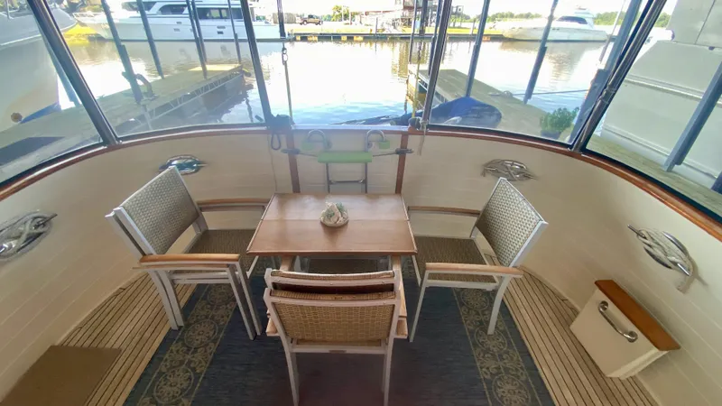 Slide: The Image of 1989 Kadey-Krogen Manatee 36 yacht interior with dining area and marina view. - 28