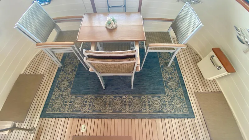 Slide: The Image of Elegant dining area on 1989 Kadey-Krogen Manatee 36 yacht with wooden table and chairs. - 29