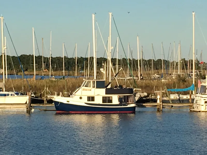 Slide: The Image of 1989 Kadey-Krogen Manatee 36 yacht docked in a marina with sailboats. - 4
