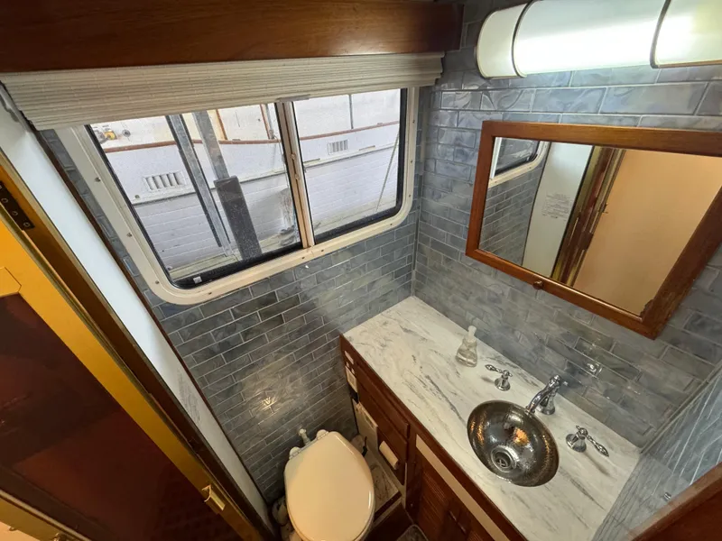 Slide: The Image of Kadey-Krogen Manatee 36 bathroom, 1989 model, featuring a sink, mirror, and window. - 40