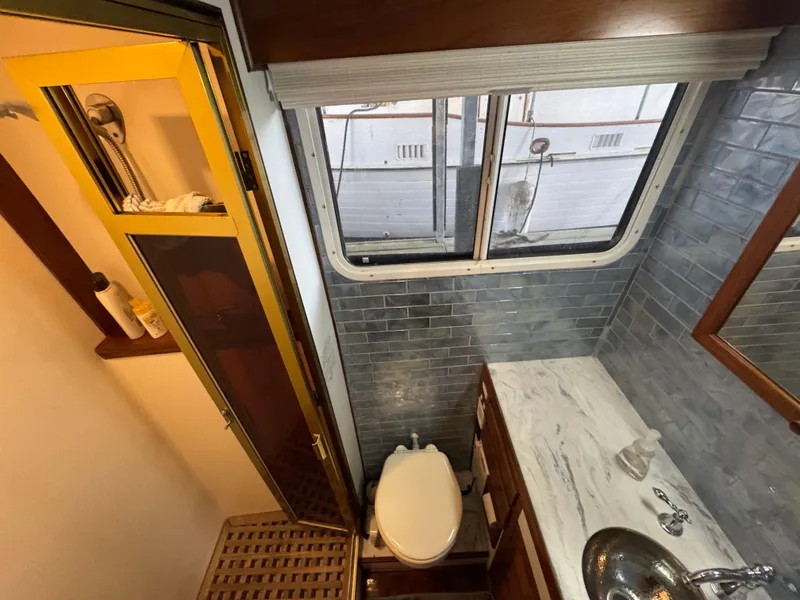 Slide: The Image of Bathroom interior of 1989 Kadey-Krogen Manatee 36 yacht with shower, toilet, and sink. - 41