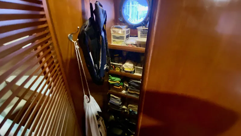 Slide: The Image of Storage area inside 1989 Kadey-Krogen Manatee 36 boat with shelves and porthole. - 43