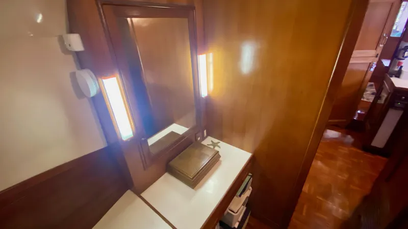 Slide: The Image of 1989 Kadey-Krogen Manatee 36 interior with wooden paneling and mirror. - 44