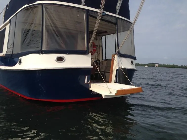 Slide: The Image of 1989 Kadey-Krogen Manatee 36 boat on water, rear view with open deck. - 7