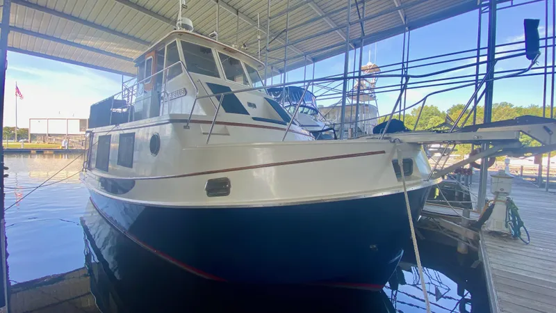 Slide: The Image of 1989 Kadey-Krogen Manatee 36 docked in a covered marina, side view. - 9