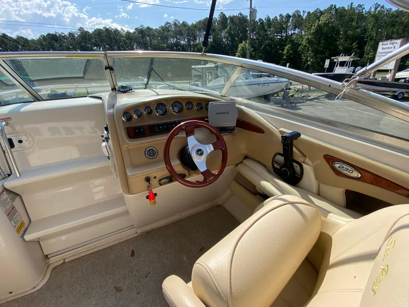 Slide: The Image of Interior view of 2000 Sea Ray 230 boat cockpit with steering wheel and dashboard controls. - 5