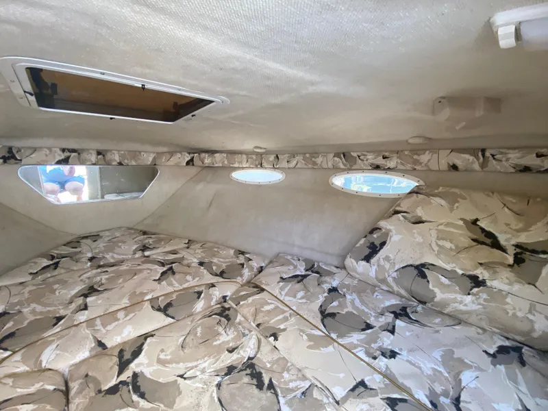 Slide: The Image of Interior cabin of a 2000 Sea Ray 230 boat with patterned upholstery. - 8