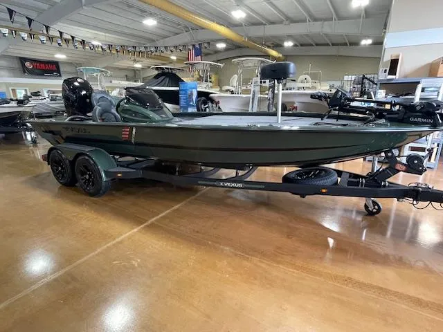 Slide: The Image of 2025 Vexus AVX 1980 boat on trailer in showroom, featuring modern design and equipment. - 0