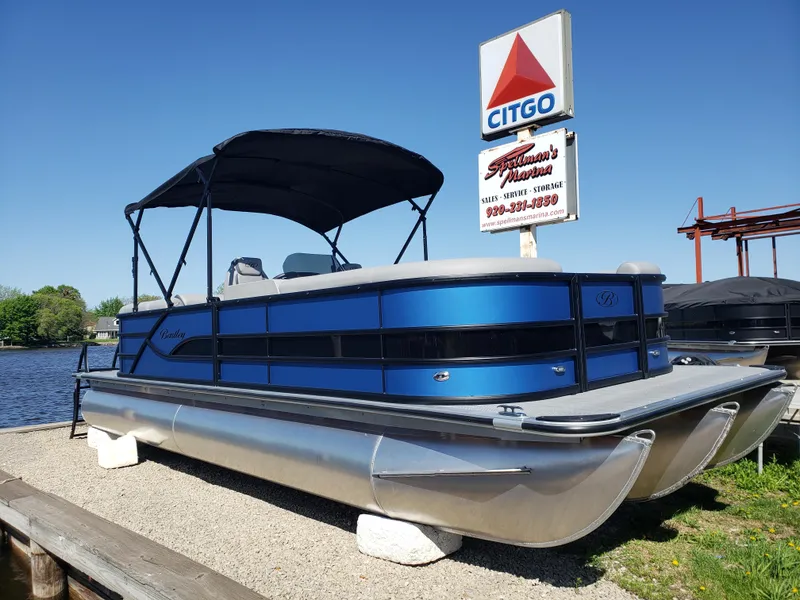 The Image of 2025 Bentley Pontoons Legacy 243 Navigator Ext at marina, under clear blue sky. - 0