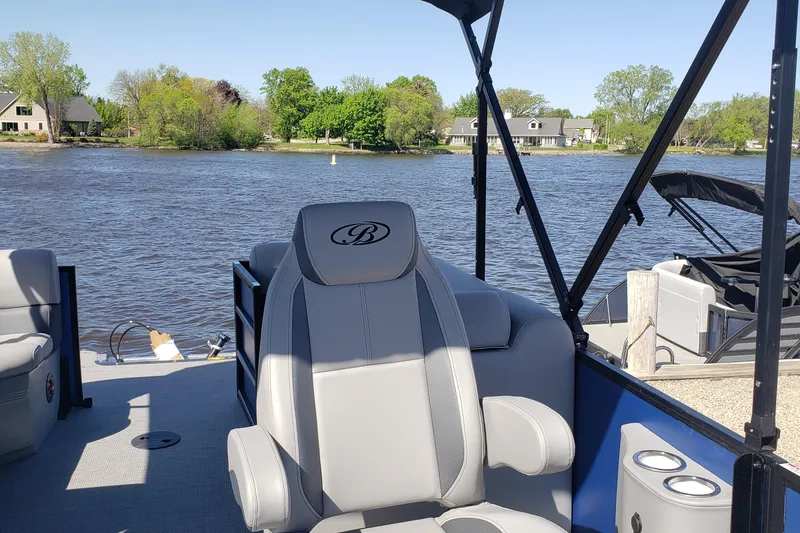 Slide: The Image of 2025 Bentley Pontoons Legacy 243 Navigator Ext on a serene lake. - 2
