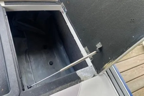 Slide: The Image of Open storage compartment in 2016 Malibu Wakesetter 25 LSV boat. - 12