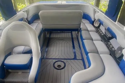 Slide: The Image of Interior of a 2016 Malibu Wakesetter 25 LSV boat with blue and gray seating. - 14