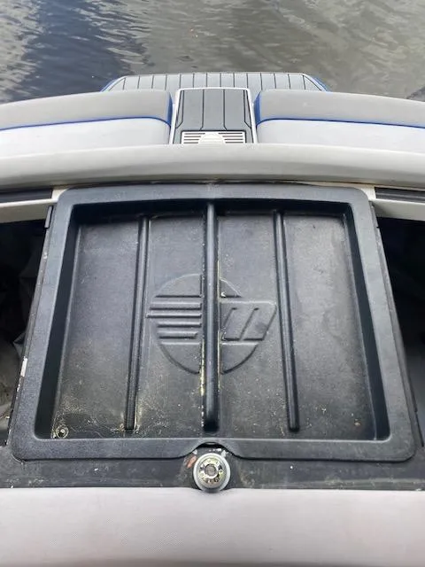 Slide: The Image of 2016 Malibu Wakesetter 25 LSV boat storage compartment by the water. - 32