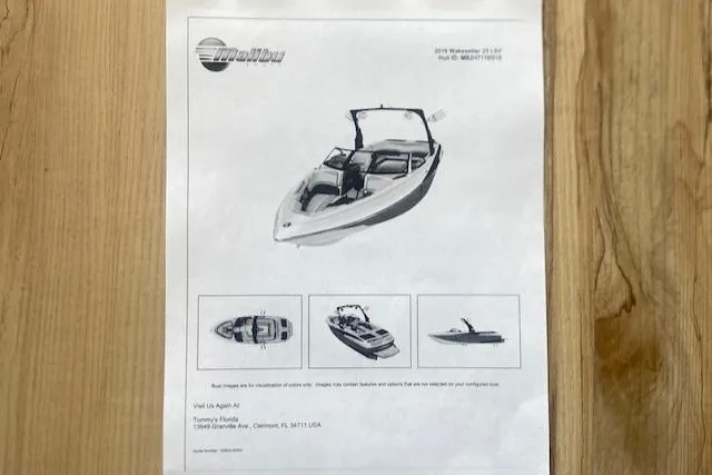 Slide: The Image of 2016 Malibu Wakesetter 25 LSV brochure on wooden surface, showcasing boat images and details. - 34