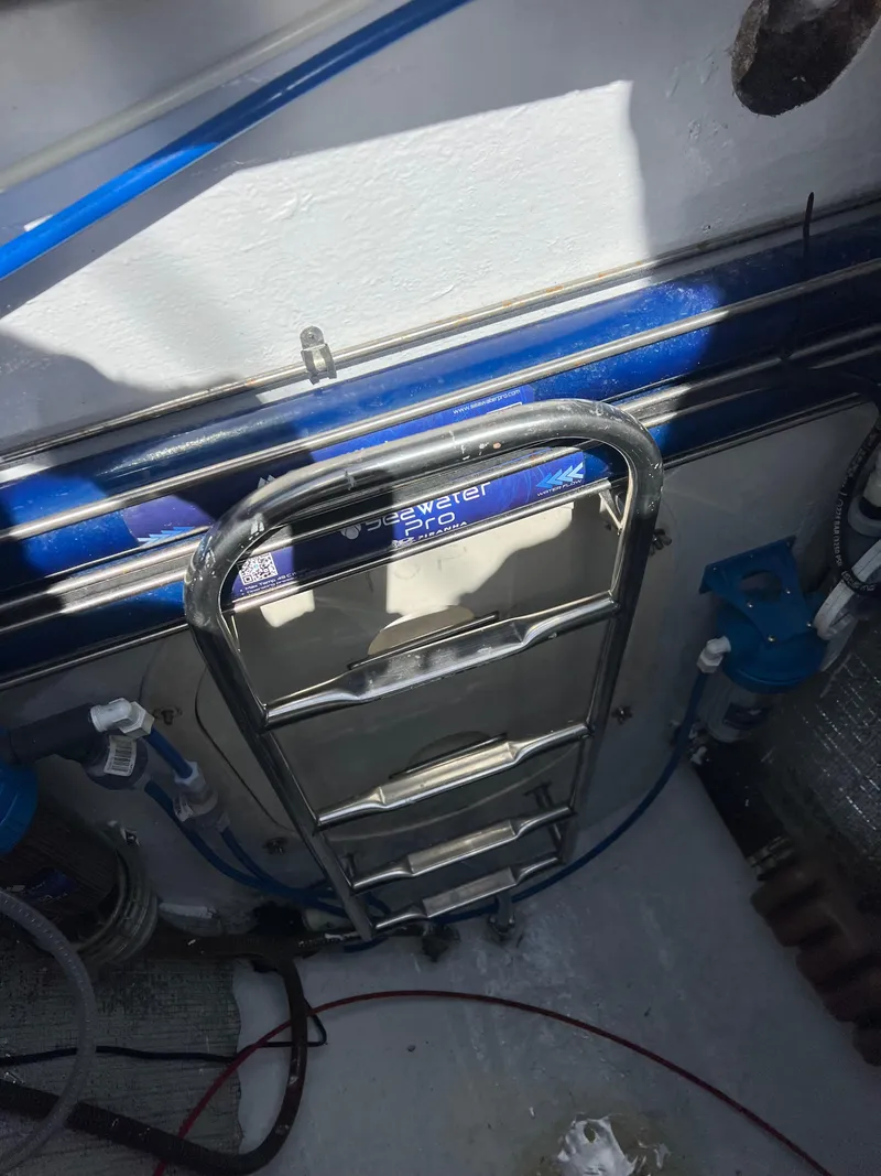 Slide: The Image of Stainless steel ladder on a 1996 Prout 45 boat deck, with visible blue piping. - 1