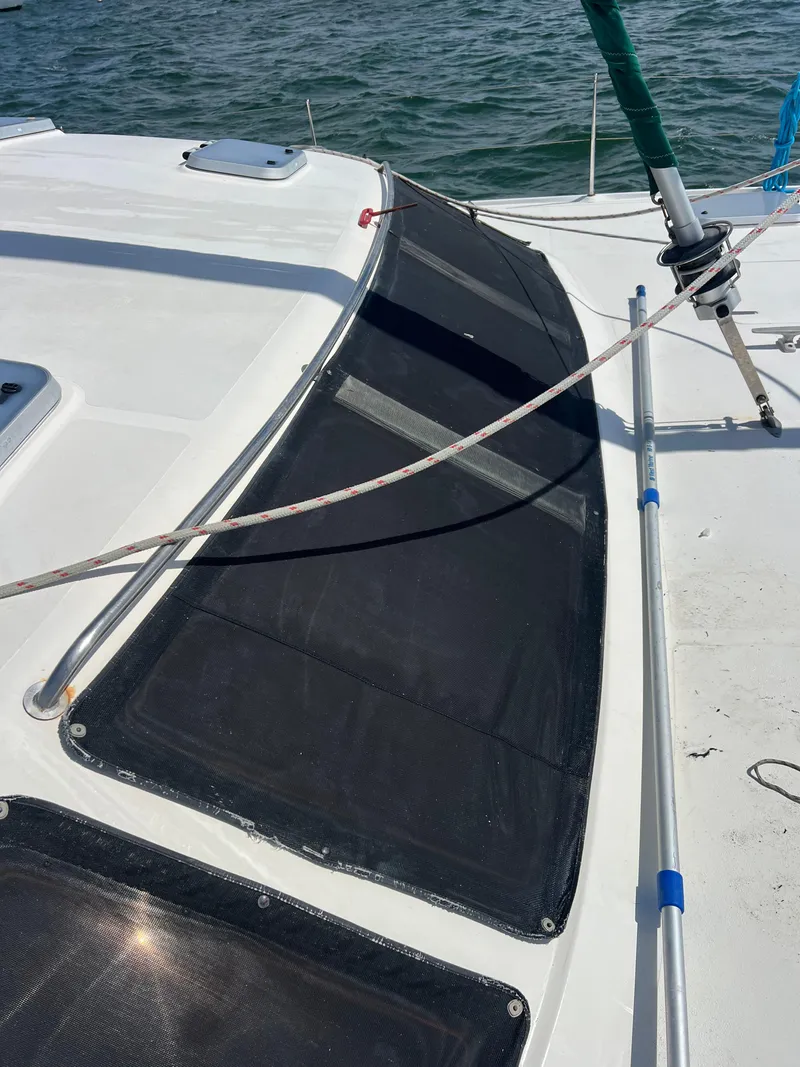 Slide: The Image of 1996 Prout 45 sailboat deck with netting and rigging, on calm water. - 11