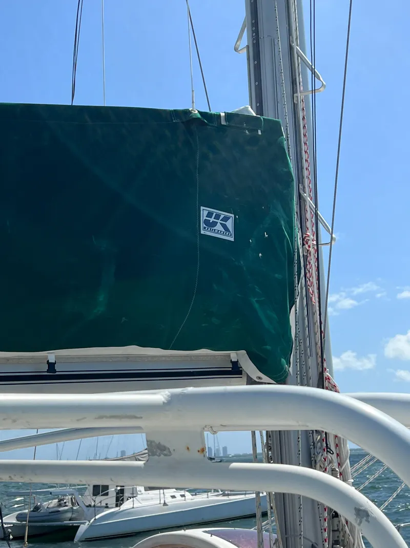 Slide: The Image of Sailboat mast and sail cover on a 1996 Prout 45 under clear blue sky. - 16