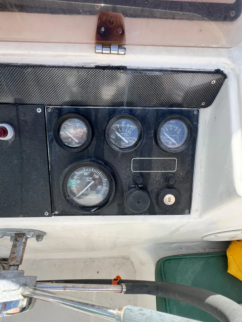 Slide: The Image of Control panel of a 1996 Prout 45 boat with gauges and switches. - 18