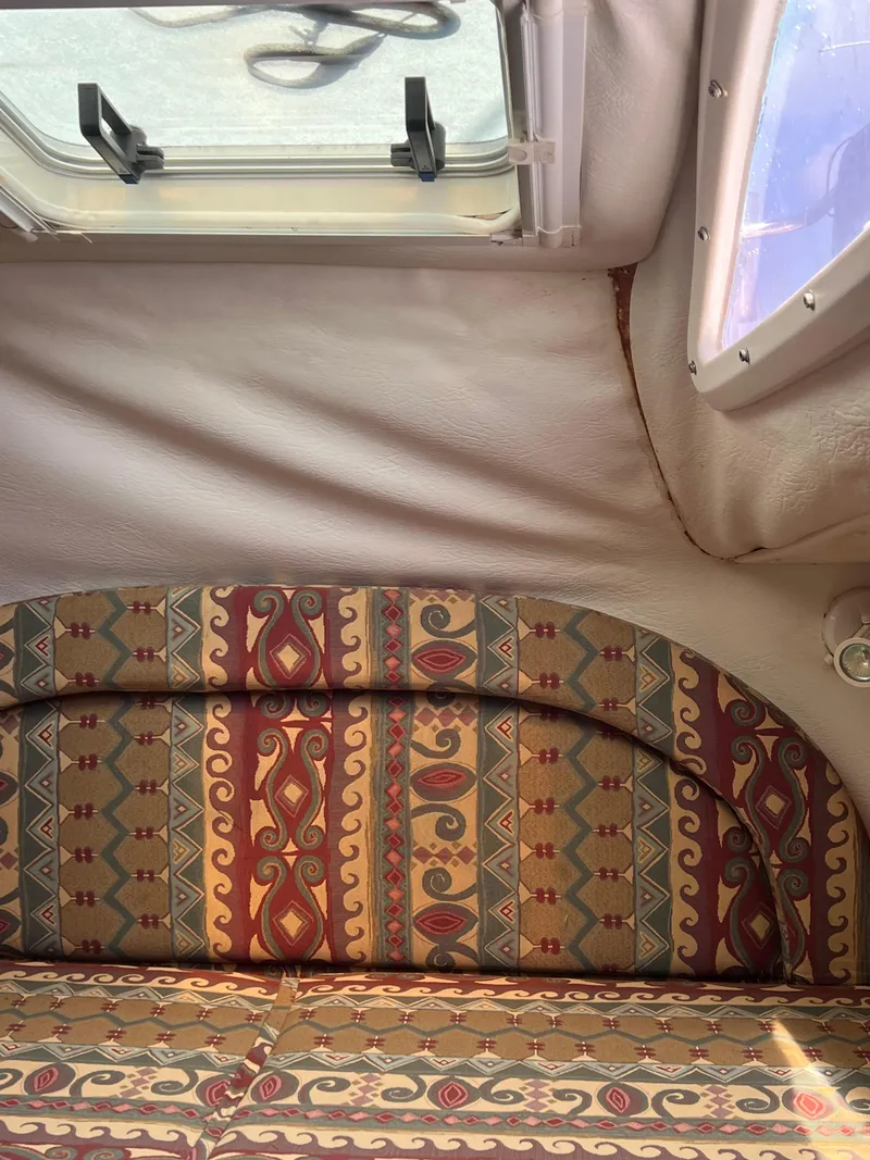 Slide: The Image of Interior of a 1996 Prout 45 boat with patterned upholstery and window. - 28