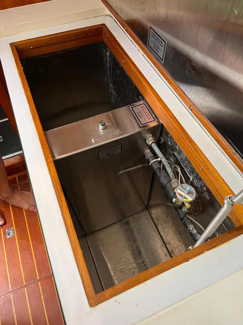 Slide: The Image of Open compartment on 1996 Prout 45 boat, showing metal tank and piping. - 33
