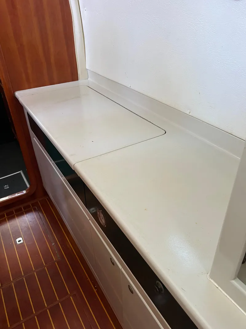 Slide: The Image of Interior of 1996 Prout 45 yacht with wooden flooring and white countertop. - 34