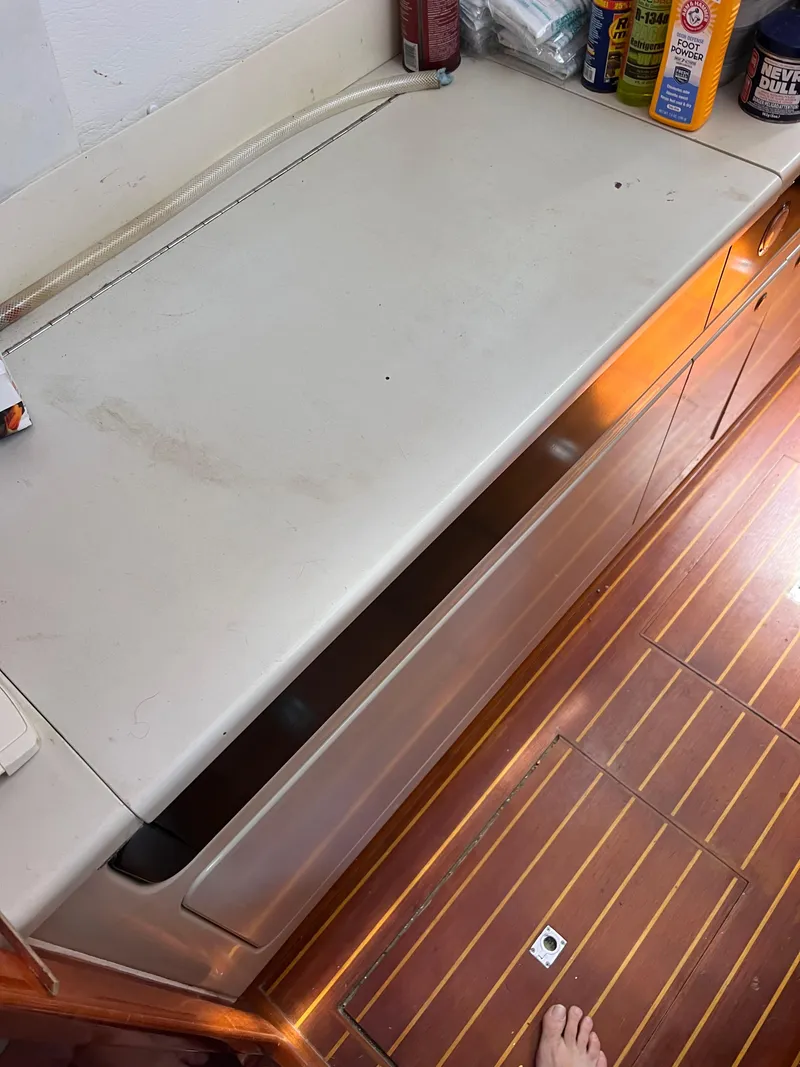 Slide: The Image of Interior view of a 1996 Prout 45 boat showing a countertop and storage area. - 35