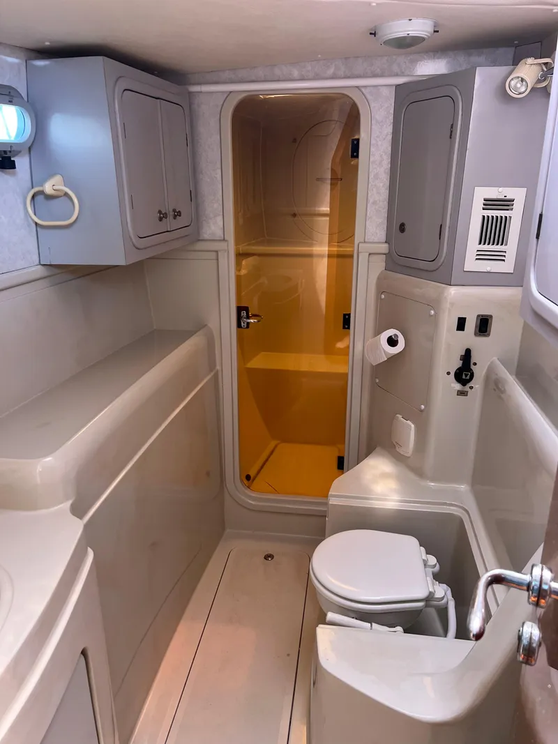 Slide: The Image of 1996 Prout 45 yacht bathroom with shower, toilet, and storage cabinets. - 37