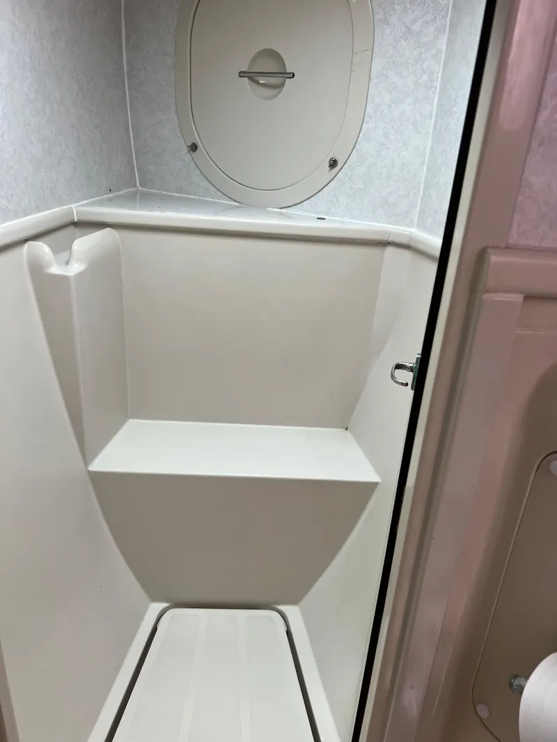 Slide: The Image of Interior of a 1996 Prout 45 boat shower area with white fixtures. - 41