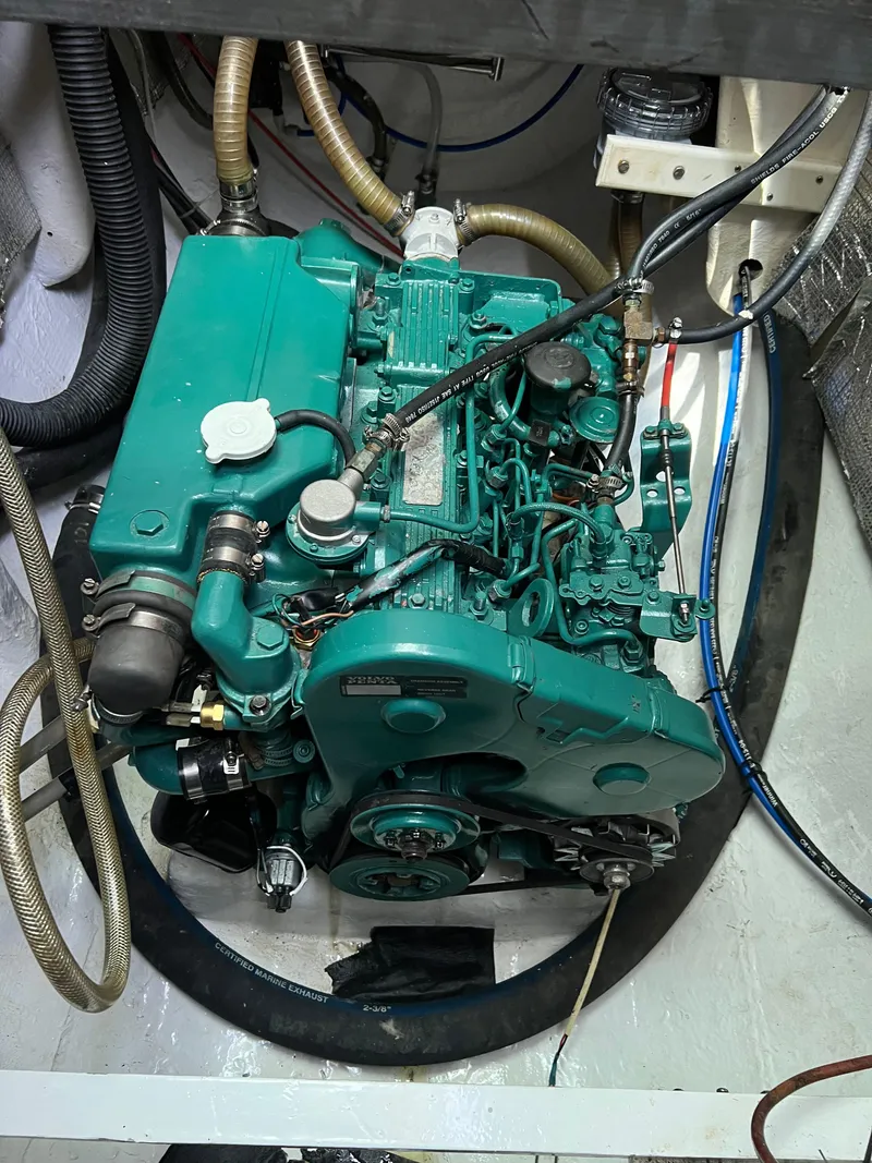 Slide: The Image of Engine of a 1996 Prout 45 boat, featuring green components and various hoses. - 44