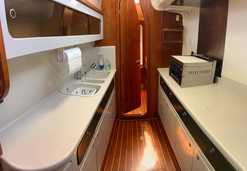 Slide: The Image of Galley kitchen in 1996 Prout 45 yacht with wood flooring and modern appliances. - 47