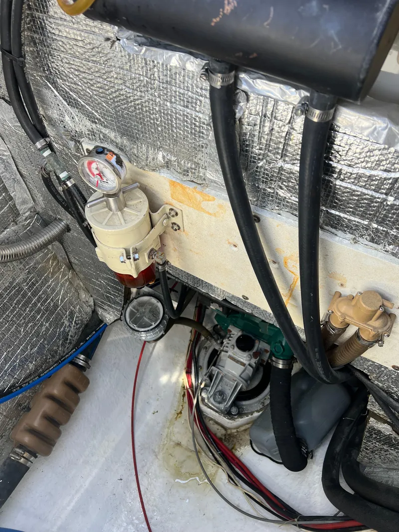 Slide: The Image of Engine compartment of a 1996 Prout 45 catamaran with visible hoses and components. - 6
