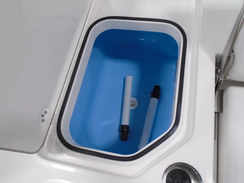 Slide: The Image of 2025 Caymas 24 HB boat livewell with blue interior and white exterior. - 15