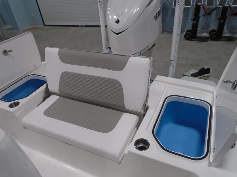 Slide: The Image of 2025 Caymas 24 HB boat interior with cushioned seating and storage compartments. - 16