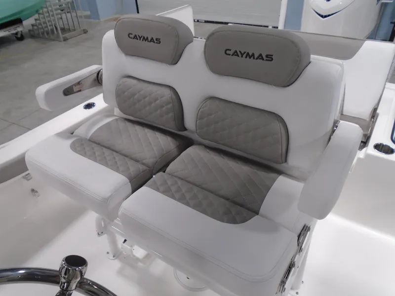 Slide: The Image of 2025 Caymas 24 HB boat seats with gray and white cushioned design. - 17
