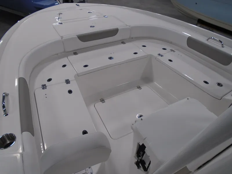 Slide: The Image of 2025 Caymas 24 HB boat interior with spacious seating and storage compartments. - 19