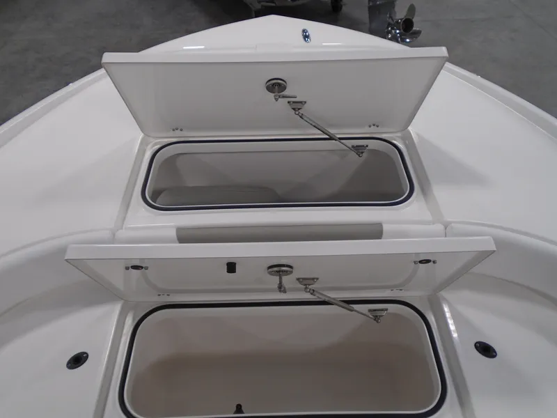 Slide: The Image of 2025 Caymas 24 HB boat storage compartments open, showcasing spacious interior design. - 20