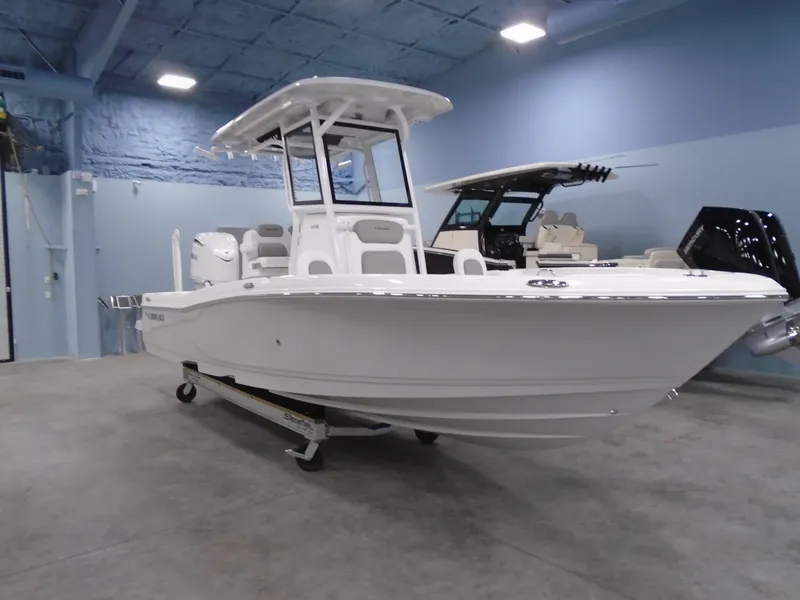 Slide: The Image of 2025 Caymas 24 HB boat in showroom, white exterior, modern design. - 3