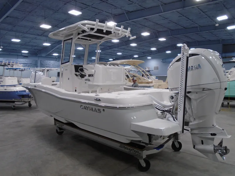 Slide: The Image of 2025 Caymas 24 HB boat in showroom, featuring sleek design and powerful engine. - 4