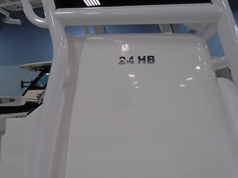 Slide: The Image of 2025 Caymas 24 HB boat interior with model name displayed. - 7