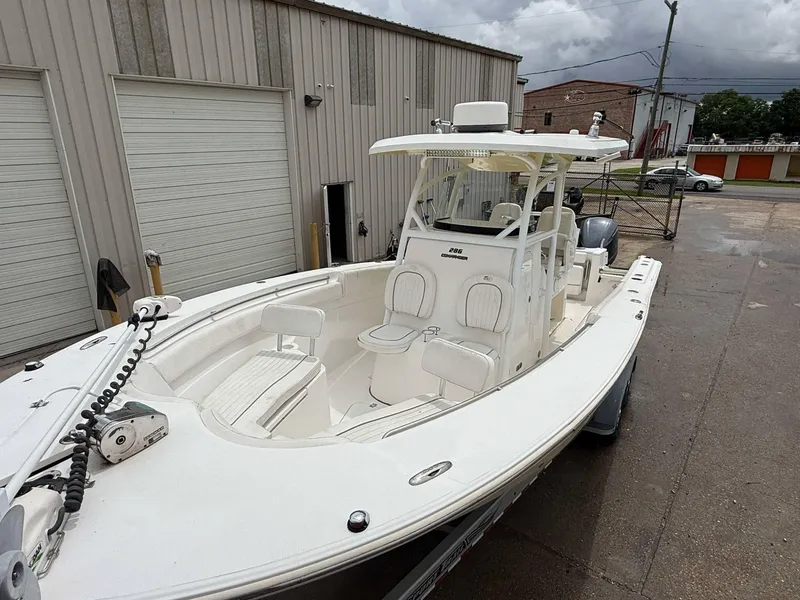 Slide: The Image of 2015 Sea Fox 286 Commander boat parked outside a warehouse on a cloudy day. - 2