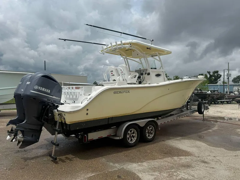 Slide: The Image of 2015 Sea Fox 286 Commander boat on trailer with Yamaha engines, under cloudy skies. - 7