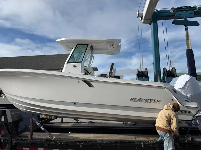 The Image of 2025 Blackfin 252 CC boat on trailer under blue sky. - 0