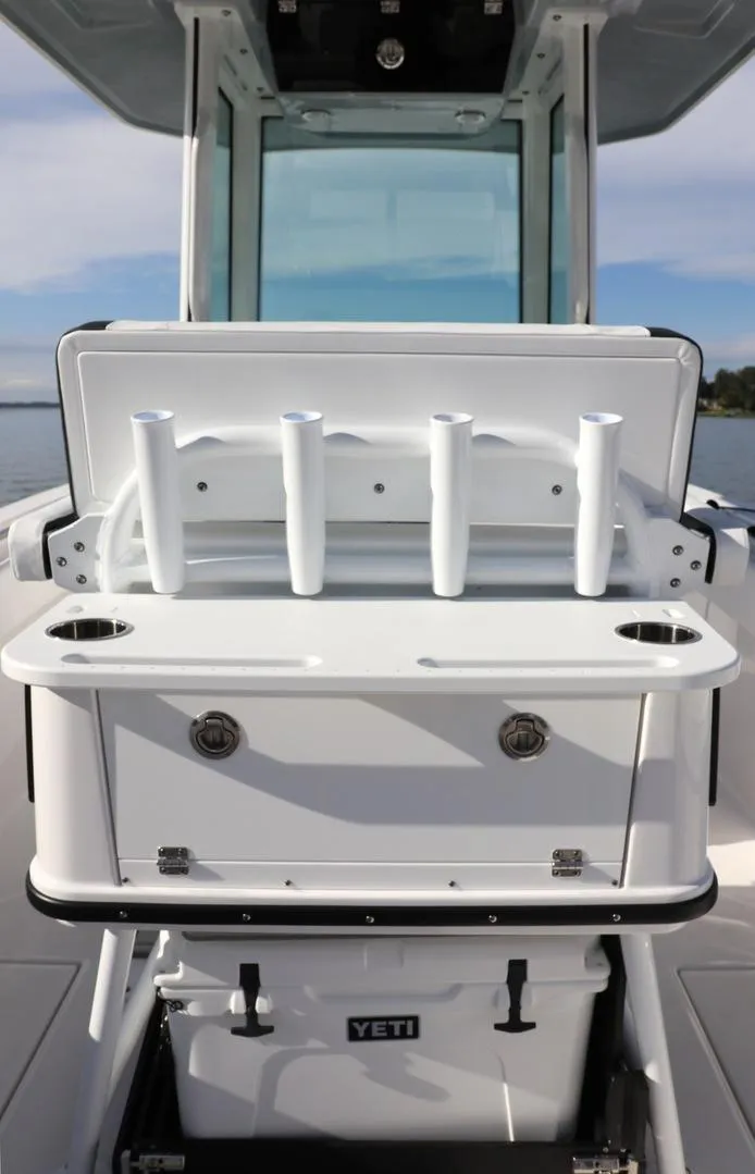 Slide: The Image of 2025 Blackfin 252 CC boat with rod holders and Yeti cooler on deck. - 6