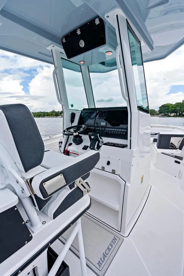 Slide: The Image of 2025 Blackfin 252 CC boat interior with modern helm and seating. - 8