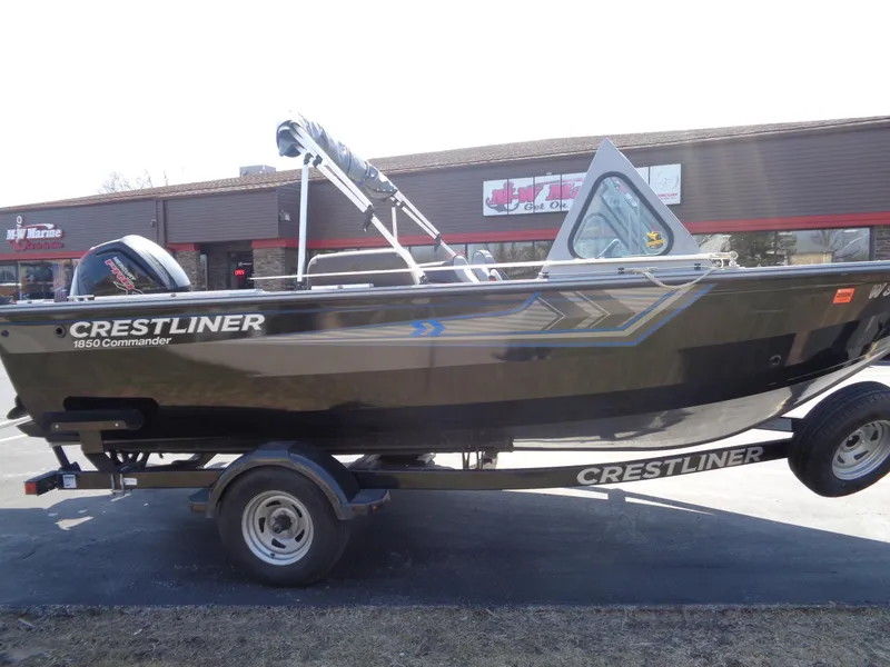 Slide: The Image of 2017 Crestliner CCM185 boat on trailer, parked outside a building. - 10