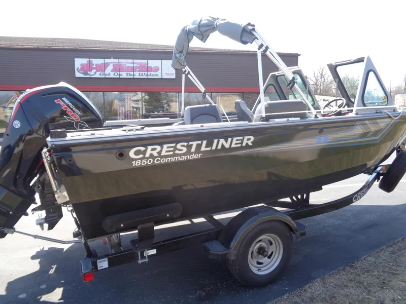 Slide: The Image of 2017 Crestliner CCM185 boat on trailer, parked outside a building. - 14