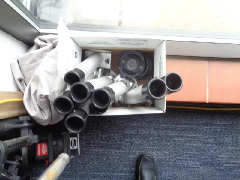 Slide: The Image of Box of metal pipes and fittings on a carpeted floor near a window. - 21